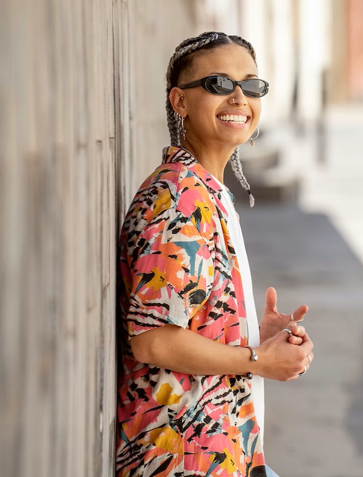 Woman in sunglasses smiling outdoors