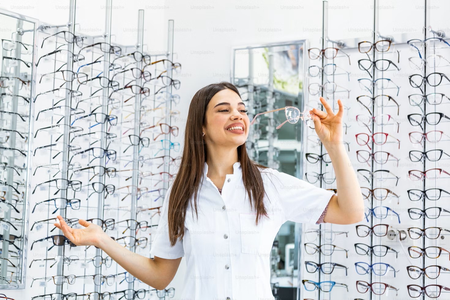 Smiling woman trying on glasses in an optical shop